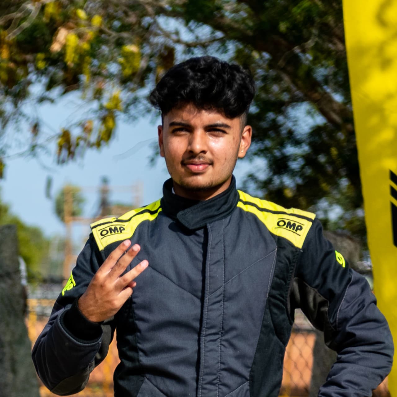 Portrait of Avi in a black and yellow race suit